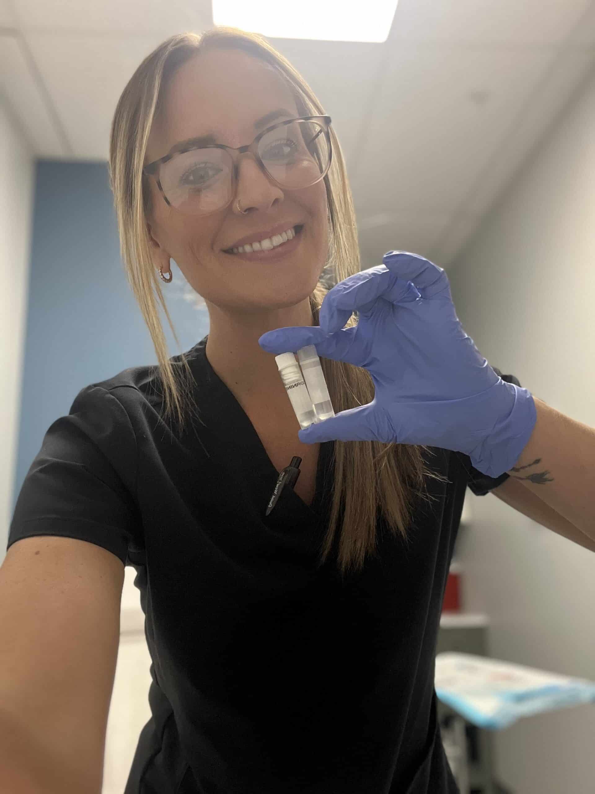 Alex Keser, Medical Assistant and Office Manager at The Stem Cell Club, holding cryopreserved mesenchymal stem cells